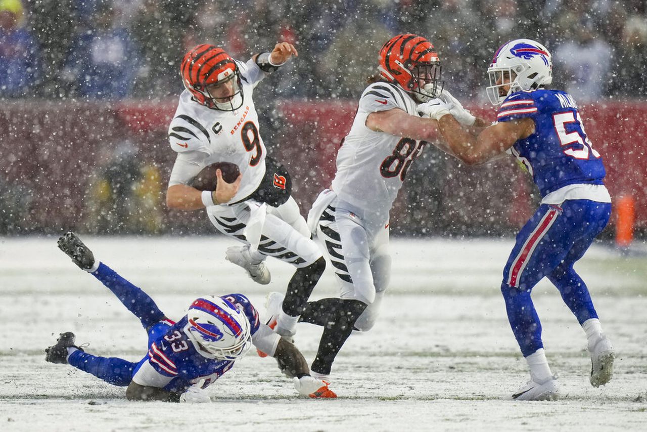 Buffalo Bills cornerback Siran Neal tackles Cincinnati Bengals quarterback Joe Burrow