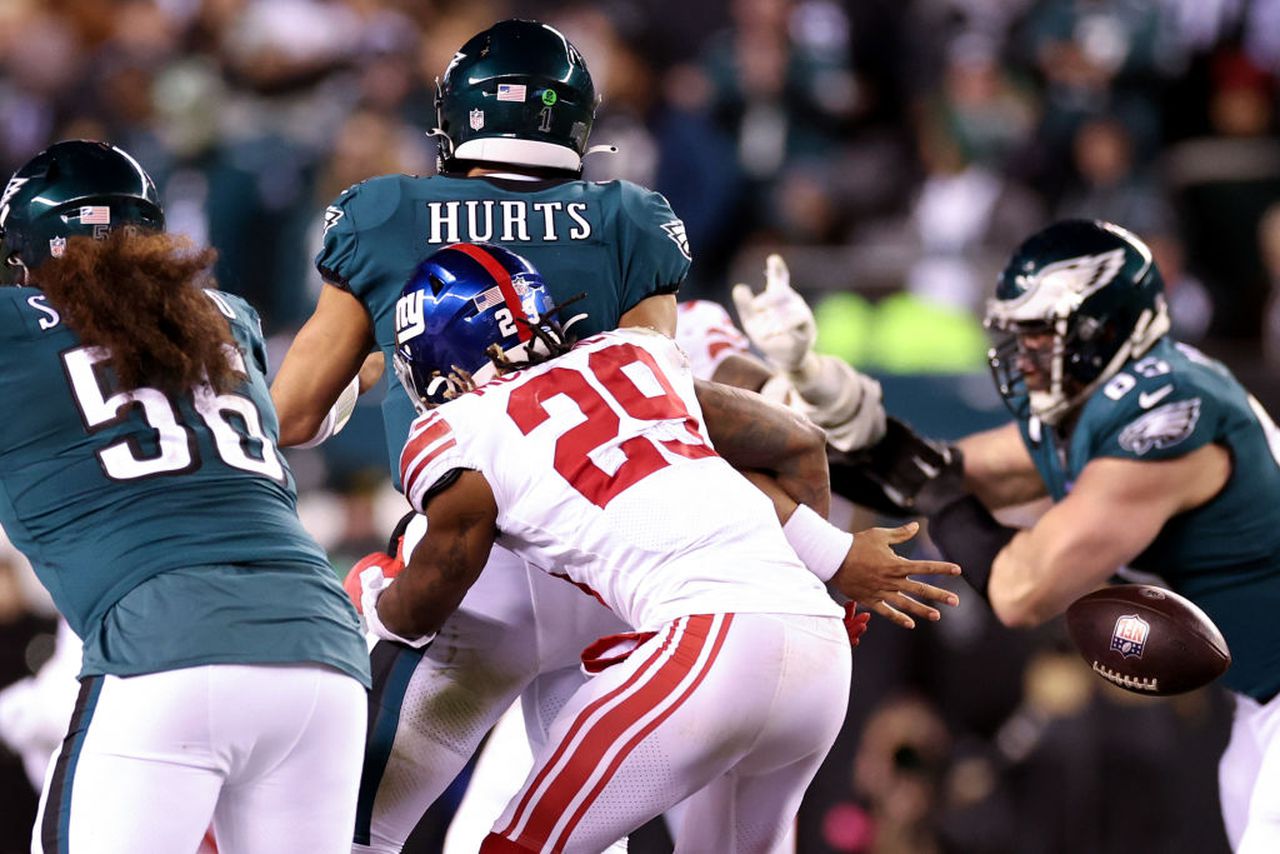 New York Giants safety Xavier McKinney knocks the football away from Philadelphia Eagles quarterback Jalen Hurts