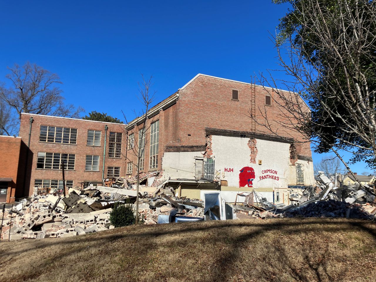 Old Huntsville school mascot mural peers out from modern rubble