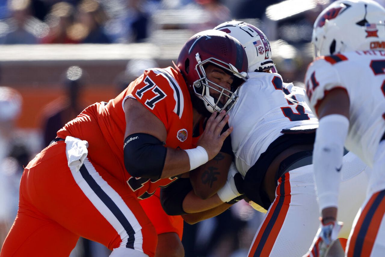 Troy center Jake Andrews blocks