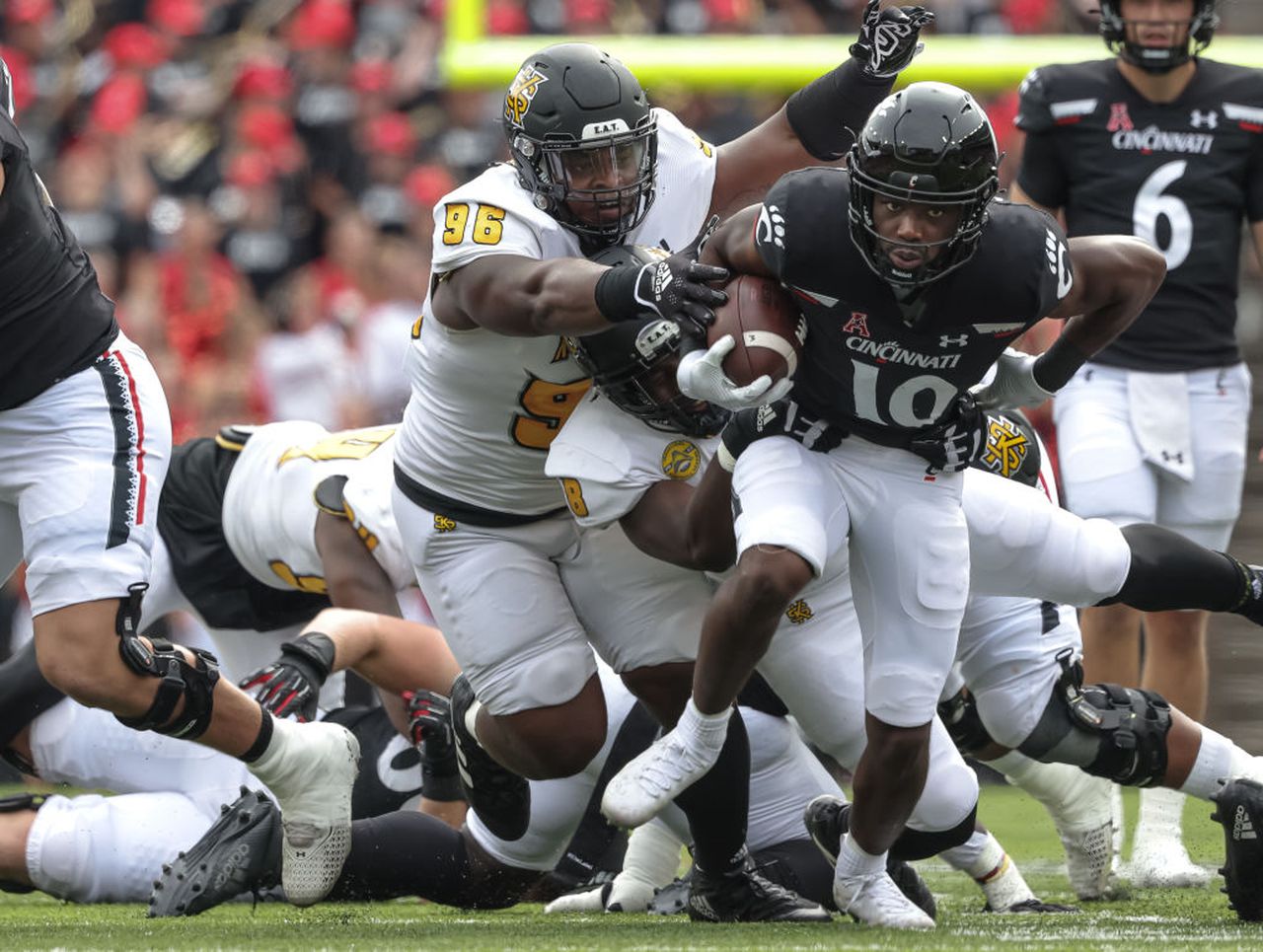 Kennesaw State defensive tackle Travis Bell grabs Cincinnati running back Charles McClelland