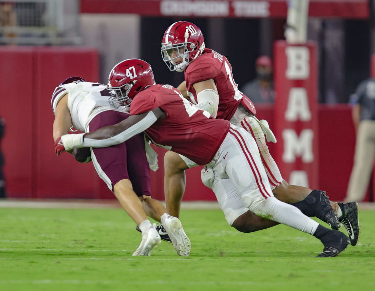 Alabama defensive tackle Byron Young tackles Mississippi State quarterback Will Rogers