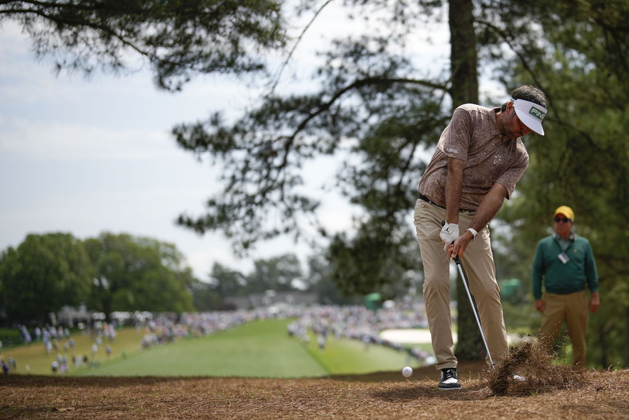 Bubba Watson hits from the pine straw on the first hole