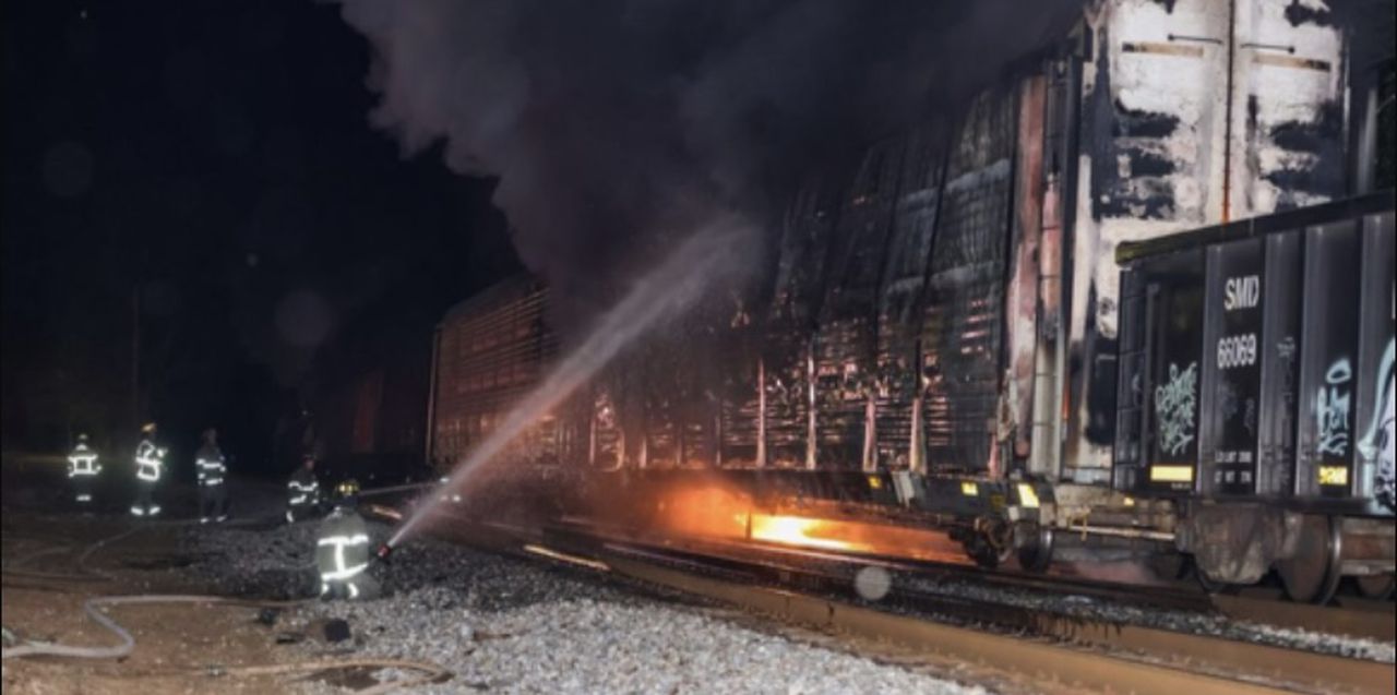 Railroad car hauling automobiles on fire in west Birmingham