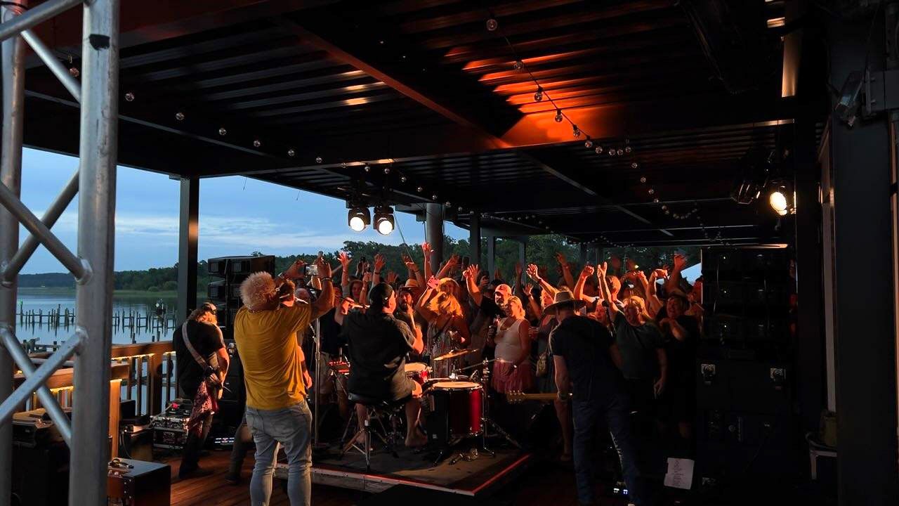 Guy Fieri (at left in yellow shirt) shoots some video as Cowboy Mouth plays at The Waterfront in Daphne on Monday, June 5, 2023.