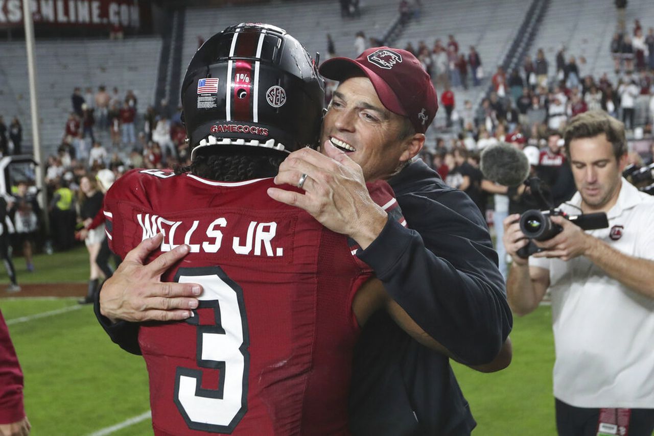 South Carolina coach Shane Beamer hugs wide receiver Antwane Wells Jr.