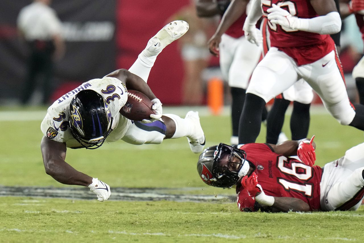 Tampa Bay Buccaneers cornerback Keenan Isaac tackles Baltimore Ravens running back Owen Wright