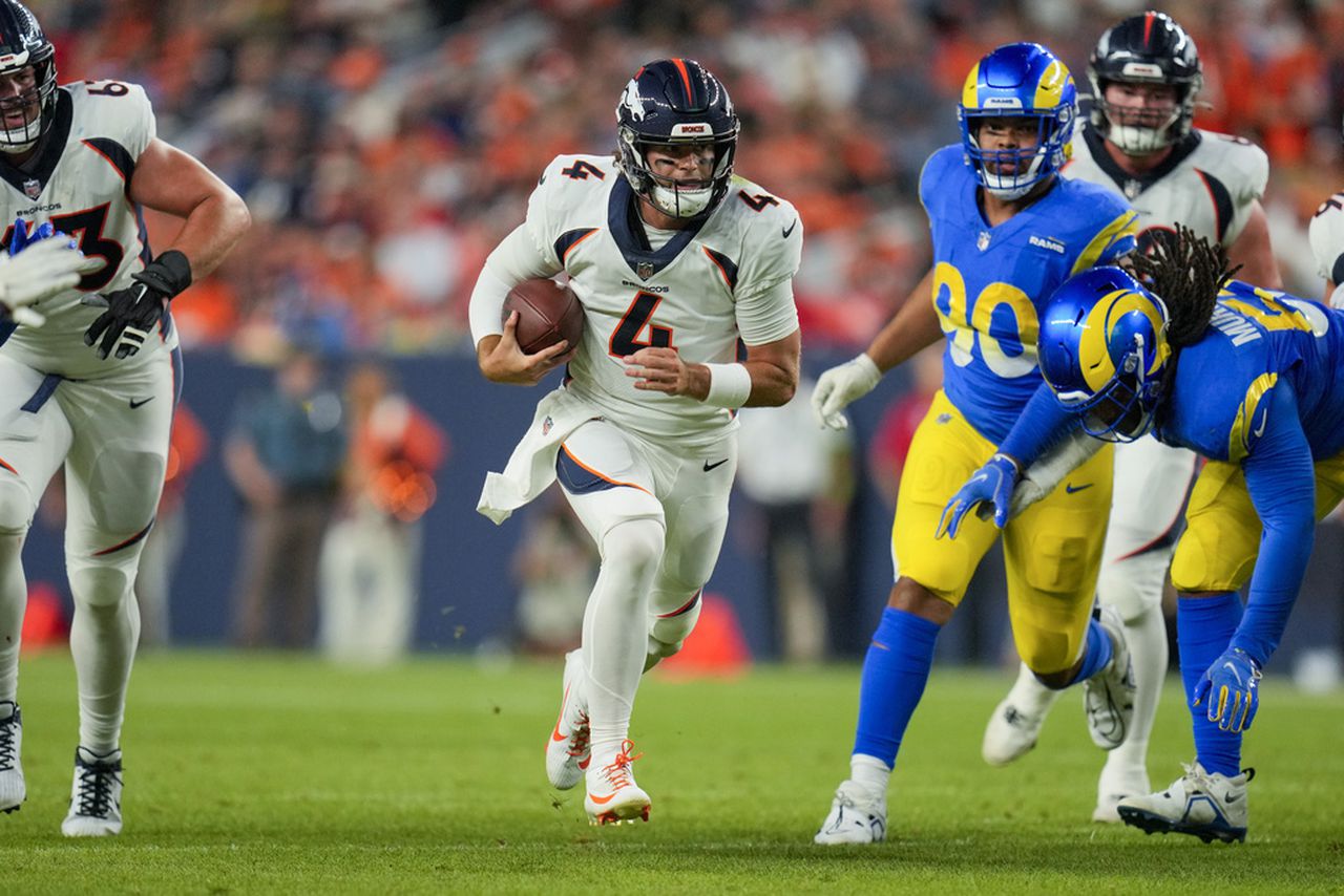 Denver Broncos quarterback Jarrett Stidham scrambles