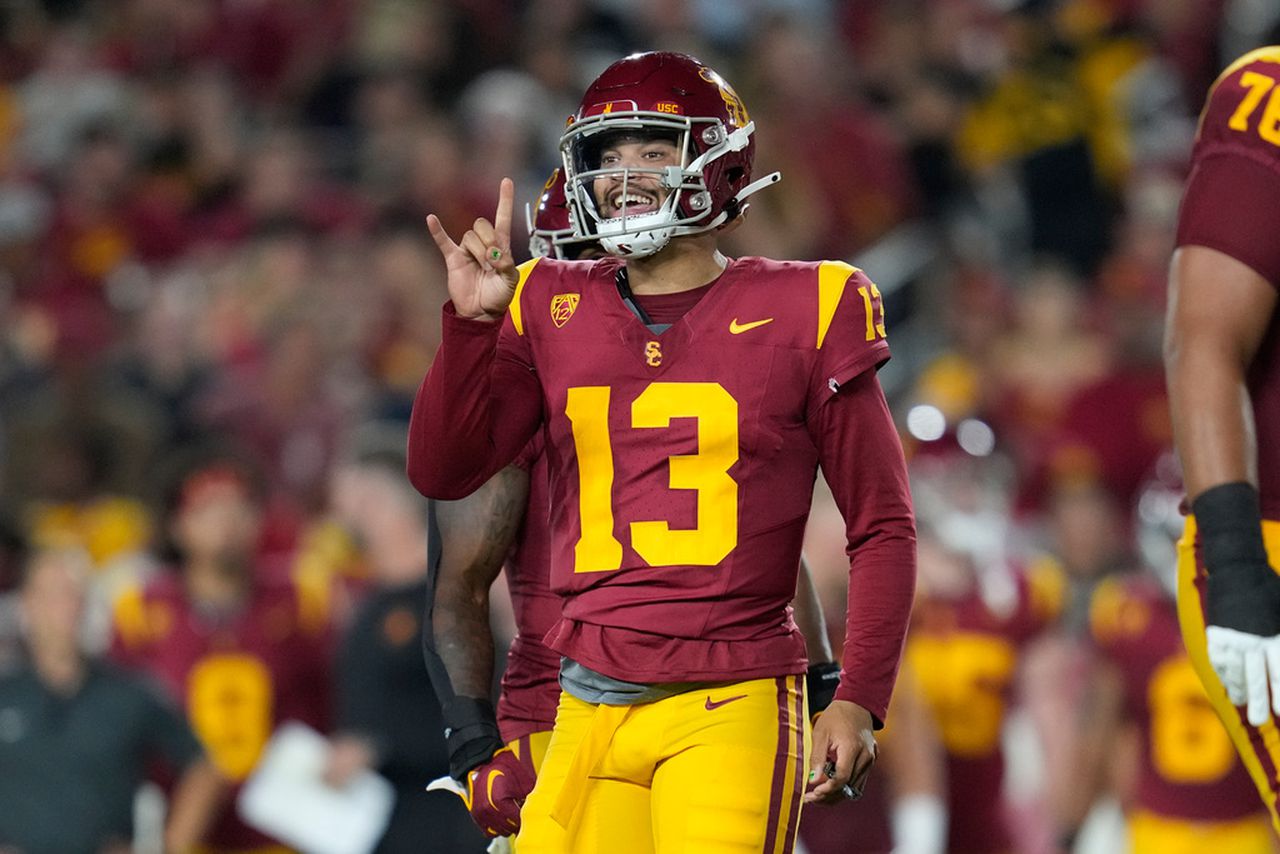 USC quarterback Caleb Williams (13) signals to a teammate during the first half of an NCAA college football game against Stanford in Los Angeles, Saturday, Sept. 9, 2023. (AP Photo/Ashley Landis)