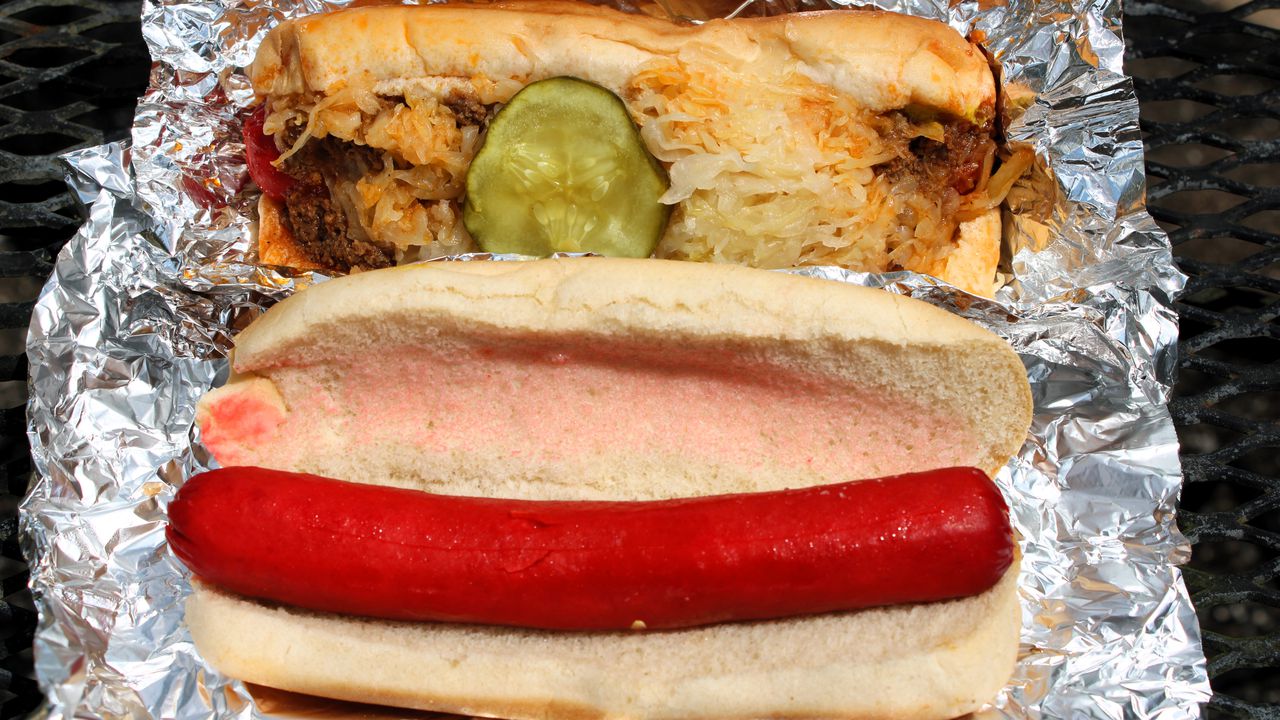 At top: A standard hot dog from Mobile's Dew Drop Inn, topped with chili and sauerkraut and other goodness. At bottom: It's true what they say about Dew Drop dogs.