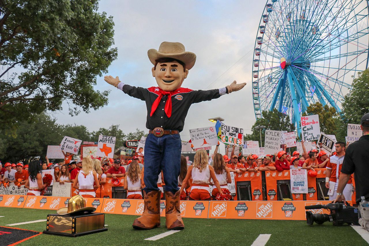 A mascot of Big Tex is seen in front of supporters of the Texas Longhorns at the State Fair of Texas.