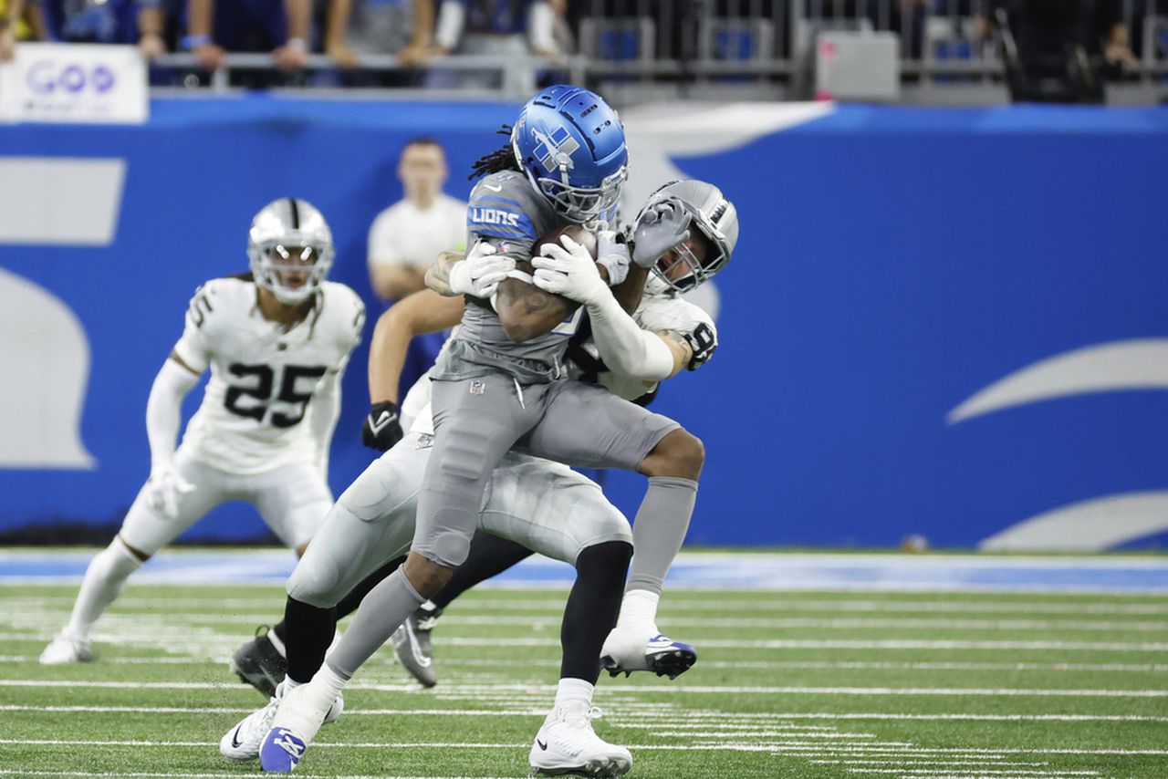 Detroit Lions wide receiver Jameson Williams gets tackled by Las Vegas Raiders defensive end Maxx Crosby