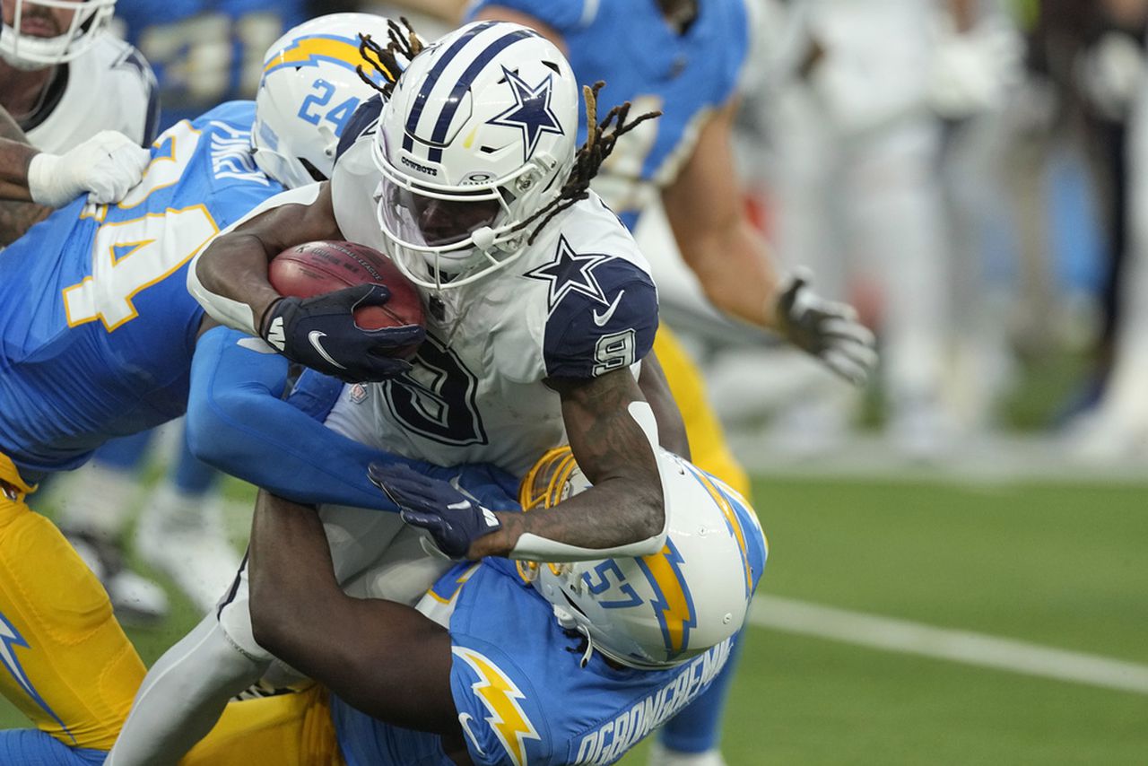 Los Angeles Chargers safety AJ Finley (24) helps bring down Dallas Cowboys wide receiver KaVontae Turpin