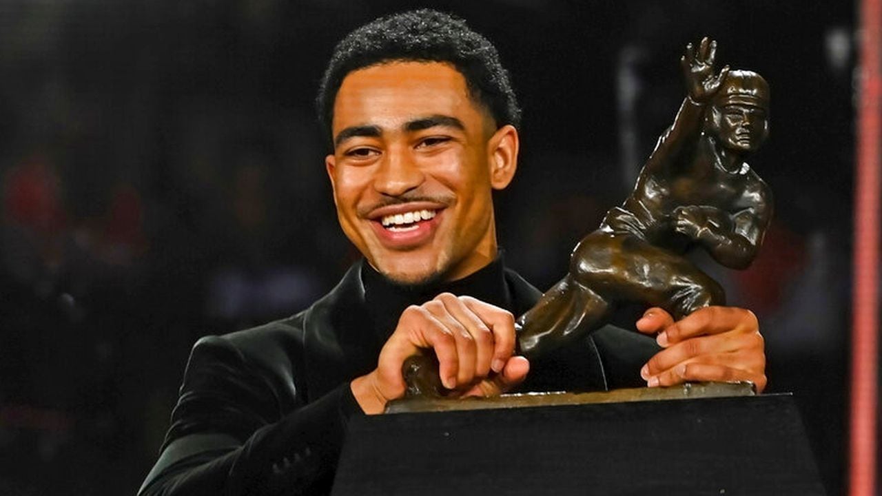 Alabama quarterback Bryce Young holds the Heisman Trophy