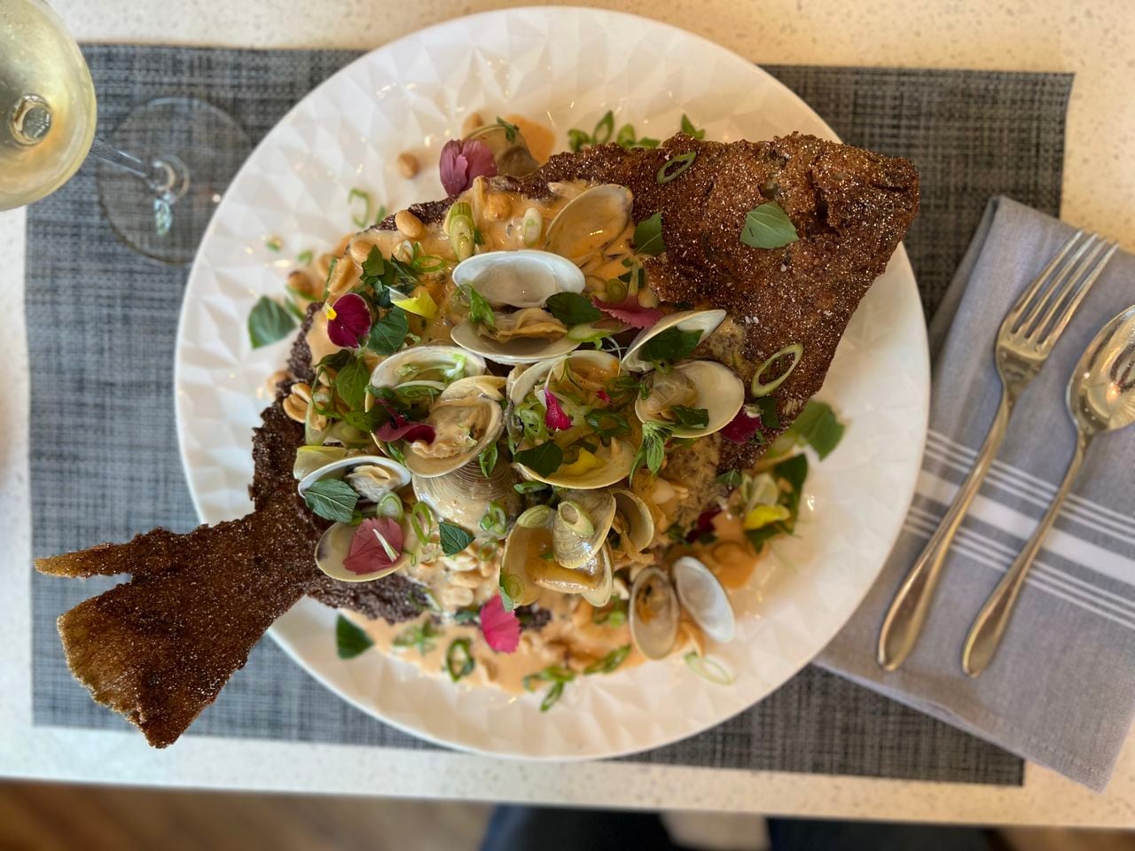 This dish of fried flounder topped with clams in curry sauce, served at The Hummingbird Way in Mobile, was showcased by "Diners, Drive-Ins and Dives."