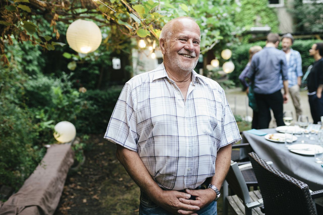 Portrait Of Elderly Man During Family Meal