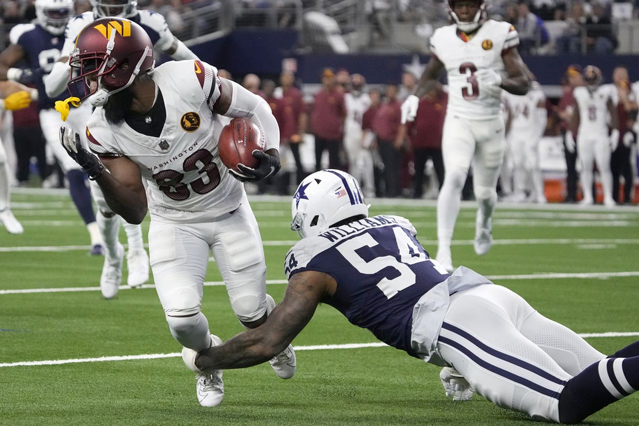 Dallas Cowboys defensive end Sam Williams tackles Washington Commanders wide receiver Jamison Crowder