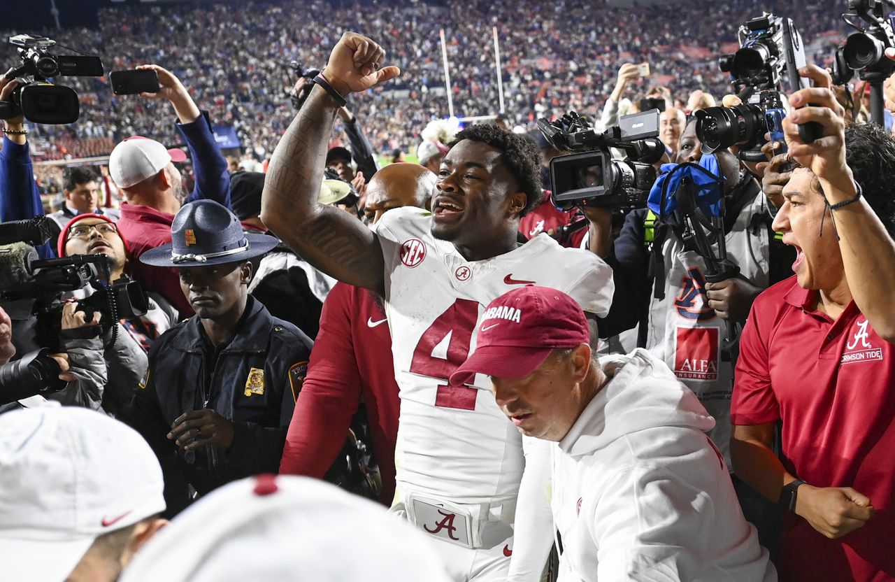 The scene as Alabama celebrated beating Auburn before departing Jordan-Hare