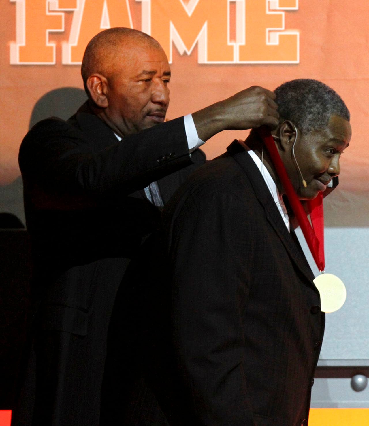 Travis Grant receives his medal from George Gervin after being inducted into the National Collegiate Basketball Hall of Fame