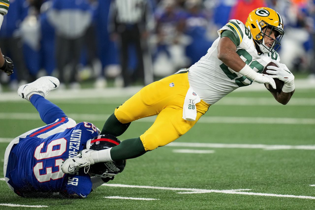 New York Giants defensive tackle Rakeem Nunez-Roches tackles Green Bay Packers running back AJ Dillon