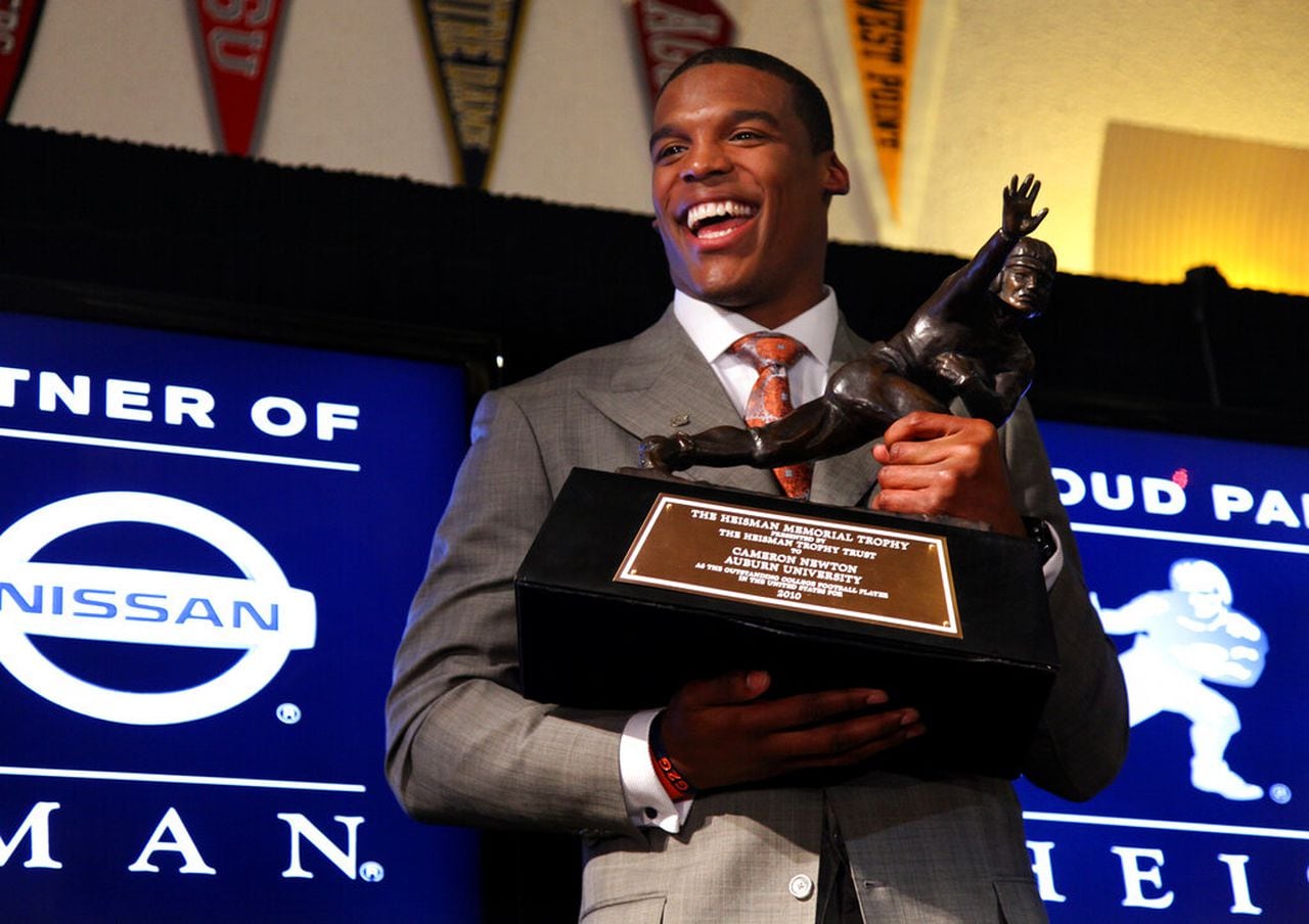 Auburn quarterback Cam Newton holds the Heisman Trophy n Dec. 11, 2010, in New York.