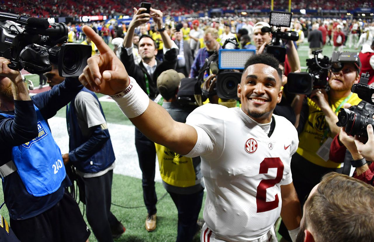 Alabama quarterback Jalen Hurts celebrates after the SEC Championship Game
