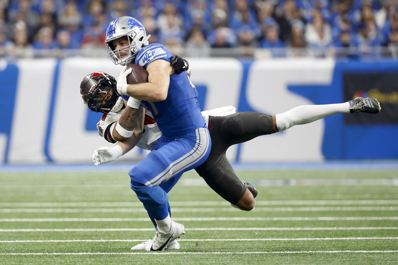 Tampa Bay Buccaneers cornerback Carlton Davis tackles Detroit Lions tight end Sam LaPorta