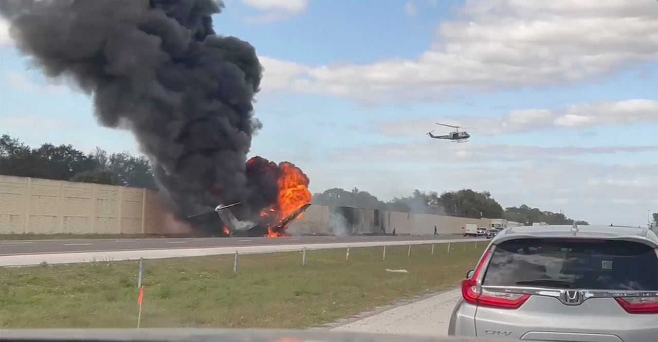 Investigators seek answers after private jet crash on Florida interstate leaves 2 dead